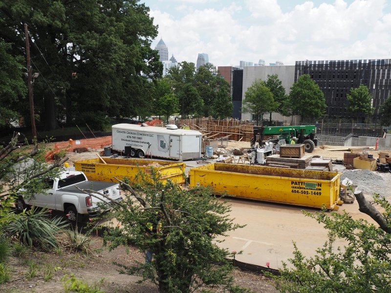 Figure 2. Construction waste dumpsters on site for wood (left) and metal (right). The third dumpster for collecting plastic bottles, paper and cardboard is outside the view of this photograph to the right.